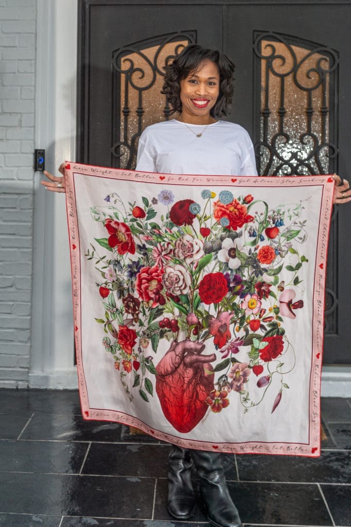 Roslyn Bazzelle Mitchell displays her commemorative American Heart Association scarf by RoKi. (Photo by PWL Studio)