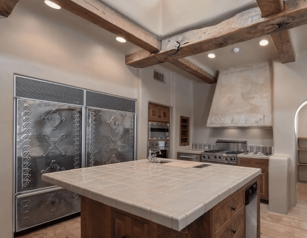 In George Strait's San Antonio home, the double SubZero freezers are covered in an intricate and hand-drawn copper design treatment that was finished in silver (Photo by LRES)