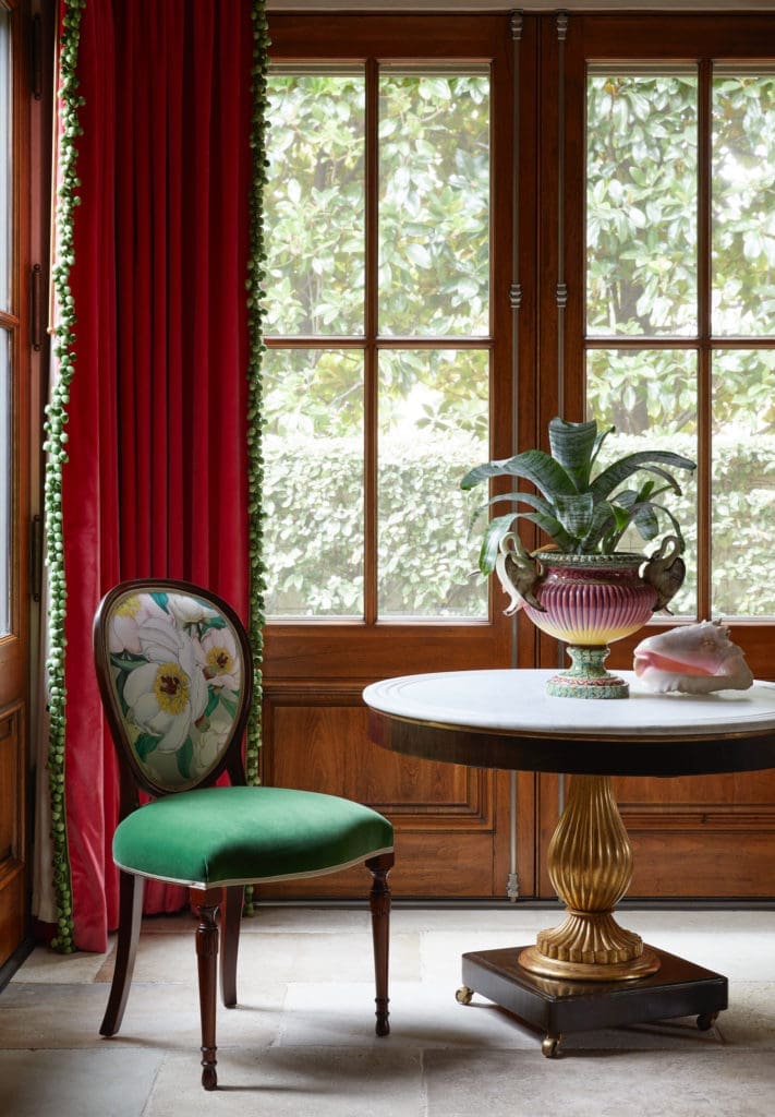 In the dining room, Biedermeier table found in North Carolina. Antique jardinière with swan handles from Paris. Chair covered in magnolia fabric from Culp Associates. (Photo by Pär Bengtsson)