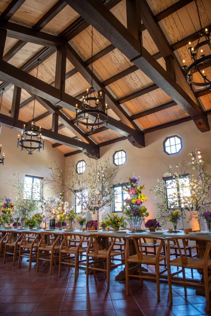 The former men's locker room at Lott Hall is set for a dinner for 24 with florals by Bergner & Johnson. The venue can handle 150 for a seated affair. (Photo by Sarah Austin of Chris Bailey Photography)