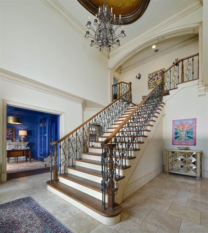 Grand entry hall with the staircase fitted with custom ironwork.