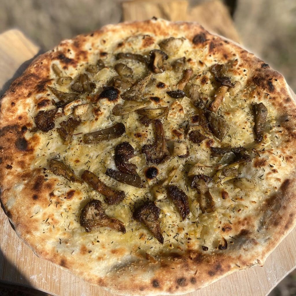 Pizza Verde pizza with three types of oyster mushrooms, sage and thyme make vegan a side note.
