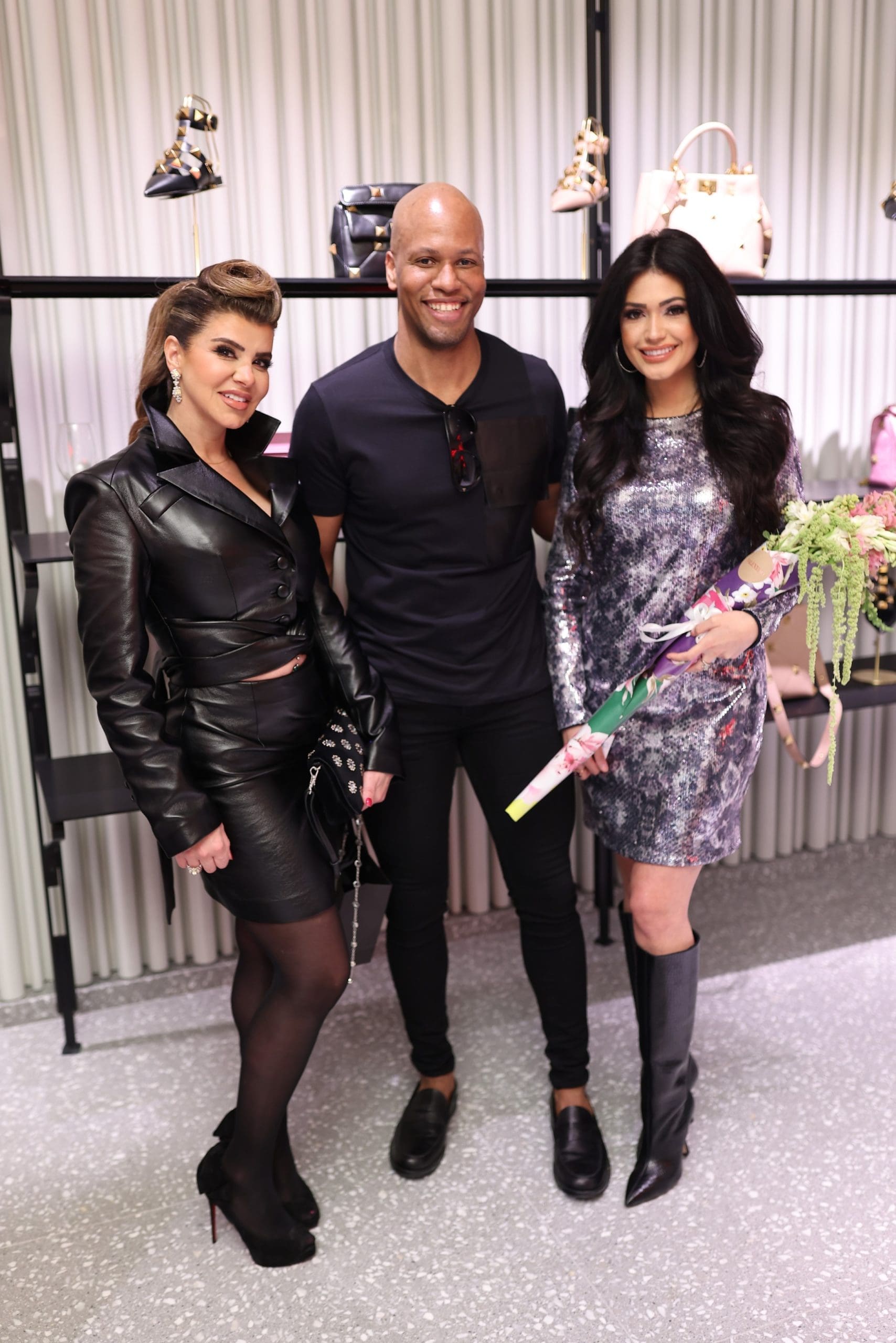Rania Edlebi, Rick Anderson, Blaine Ochoa at the Valentino boutique opening in The Galleria benefiting  Fabrica de Milagros in the Dominican Republic. (Photo by Quy Tran)