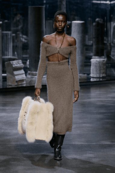 Fendi knit bralet and skirt with oversized Fendi fur bag. (Photo courtesy of Fendi)