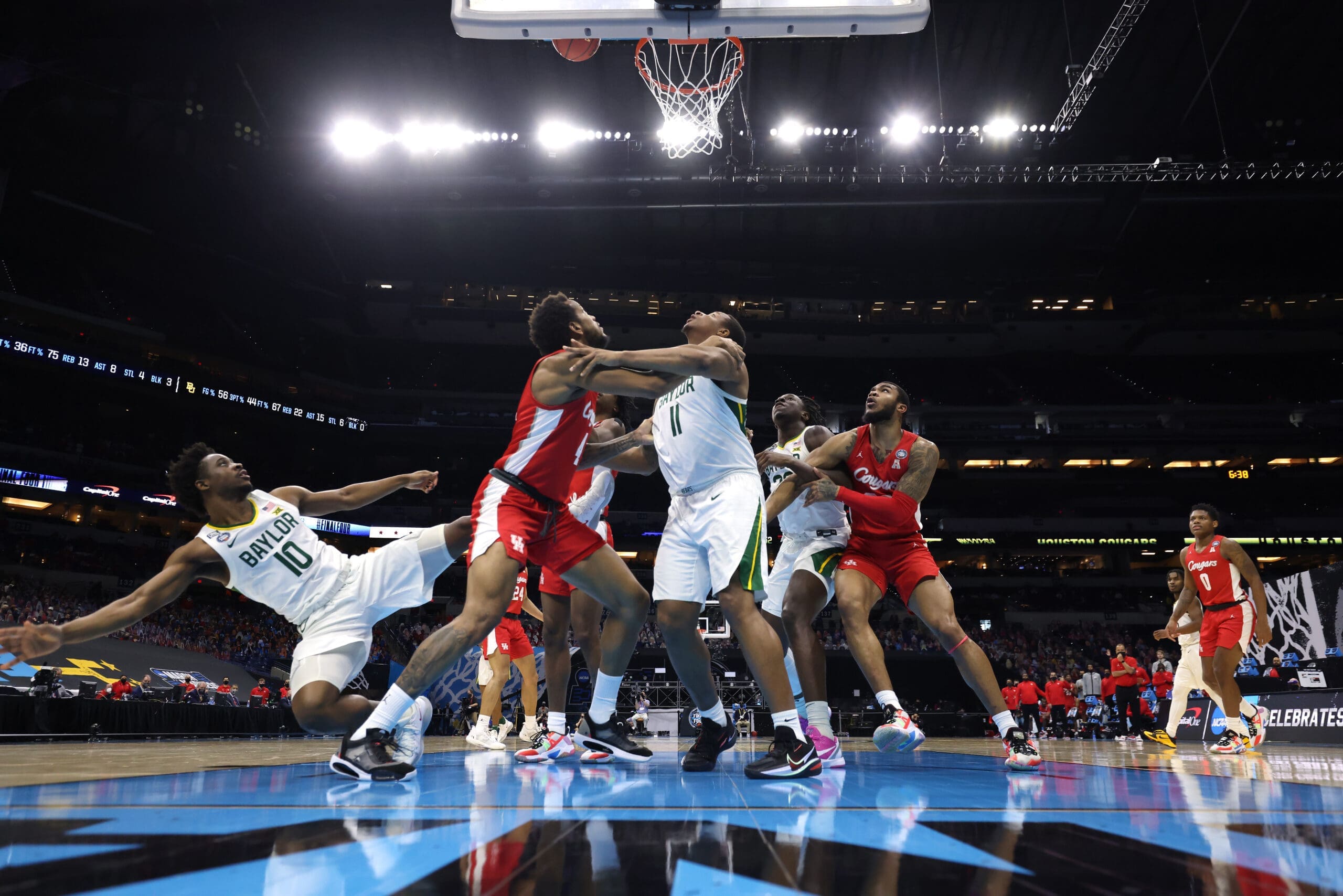 Adam Flagler #10 goes flying as teammate Mark Vital #11 of the Baylor Bears battles Justin Gorham #4 of the Houston Cougars for position to rebound the ball in the Final Four.. (Photo by Brett Wilhelm/NCAA Photos via Getty Images)