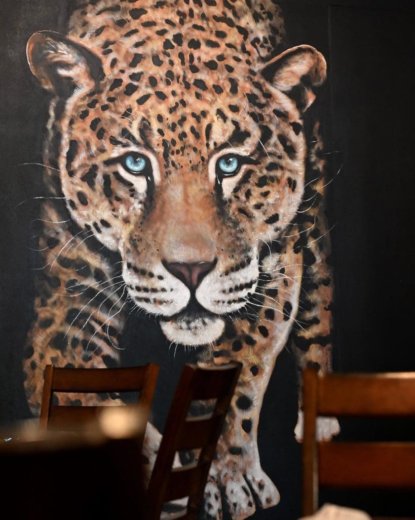 The interior of Ocho Latin Cuisine boasts large paintings of leopards, peacocks, and hummingbirds. (Courtesy of Ocho)