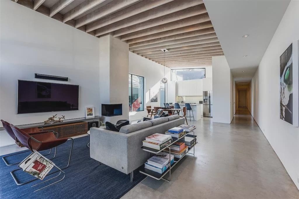 Vaulted wood beam ceilings add a beautiful touch to the versatile living area.