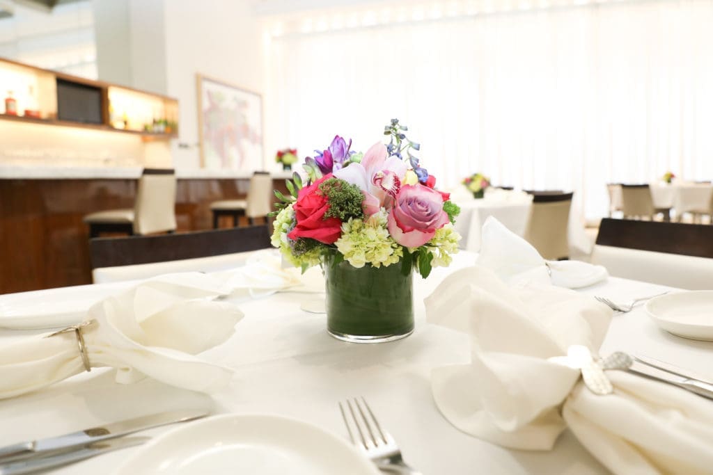 Flowers decorate tables in Mariposa, the third floor cafe in the Houston Neiman Marcus.