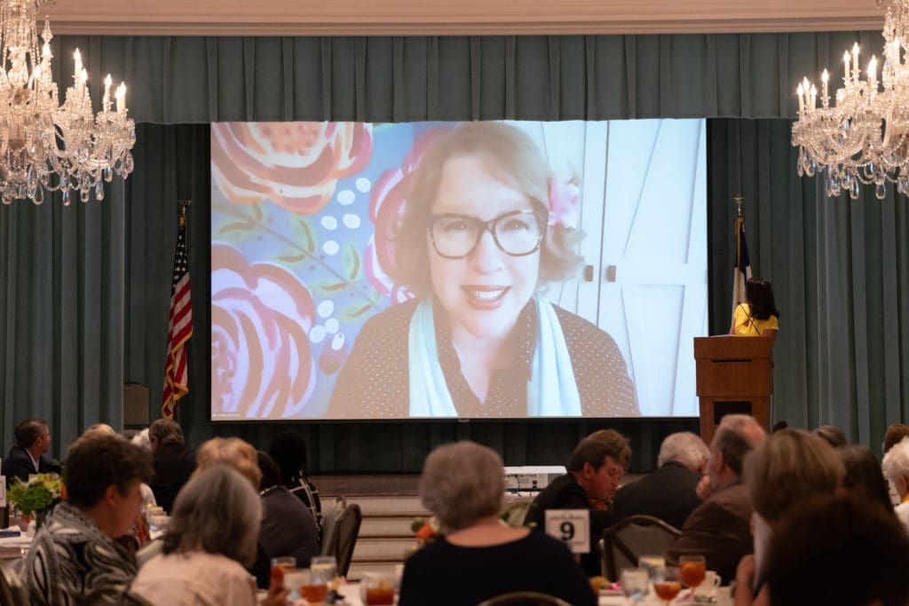 COVID Cautious Author Delivers an Uplifting Presentation From Home For a Lively Junior League Ballroom