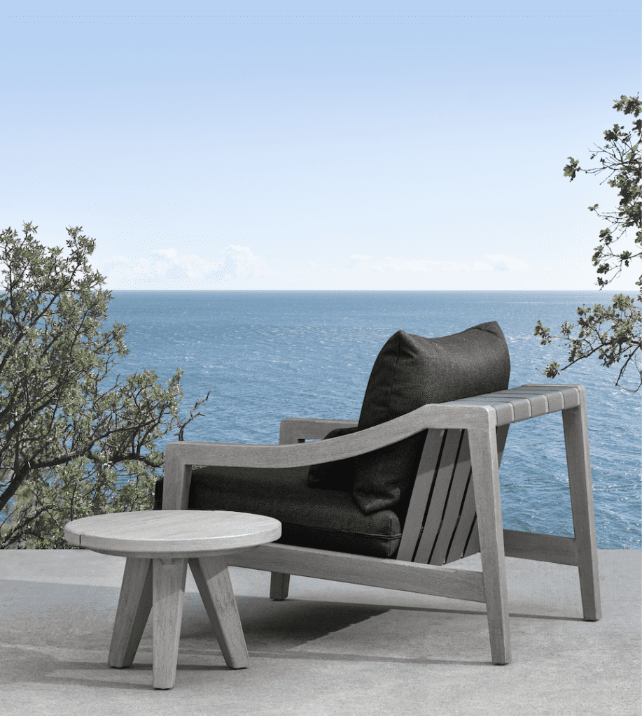 The weathered teak chair and side table are part of Mitchell Gold + Bob Williams' Del Mar outdoor collection. 