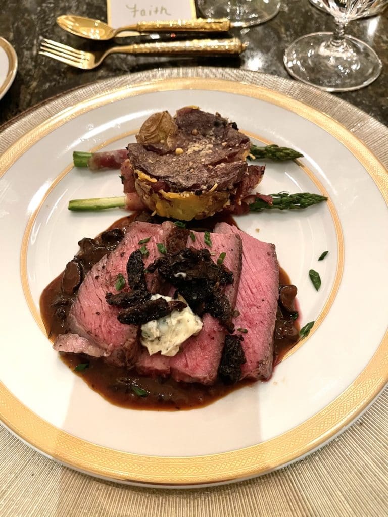 Sliced Tomahawk Ribeye, topped with morel mushrooms, was centerpiece of Guy Fieri's six-course meal served for Lee Majors' birthday.