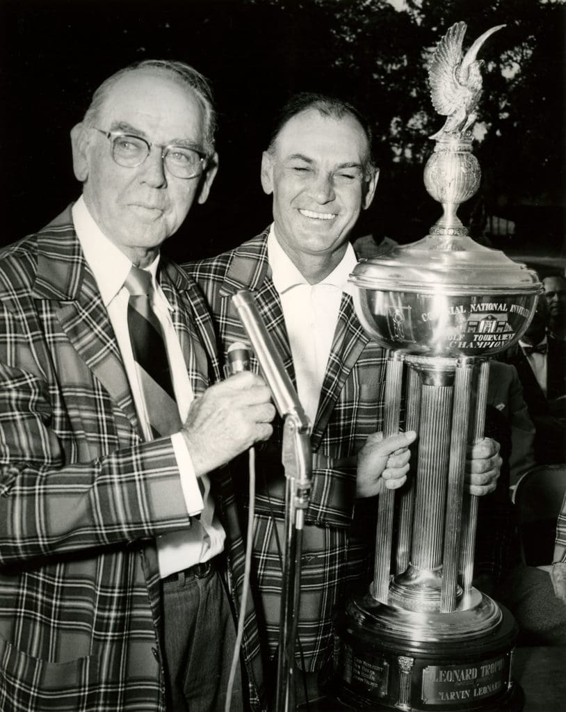 Marvin Leonard and Ben Hogan wrapped in plaid jackets holding the Leonard Trophy after one of Hogan's Colonial wins.