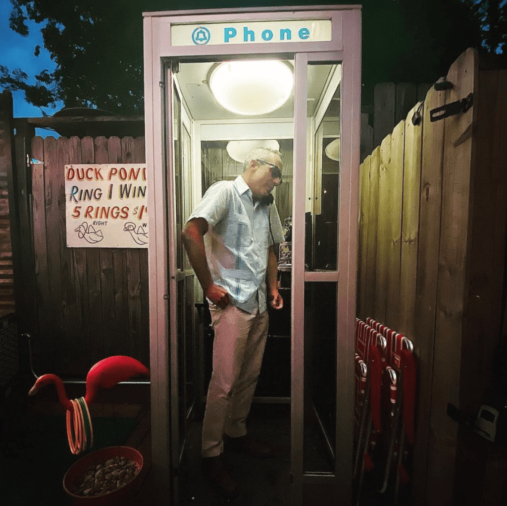 Mark Sullivan joins the kitschy fanfare in the old school telephone booth at Fat Boots Trailer Park Bar. (Instagram photo)