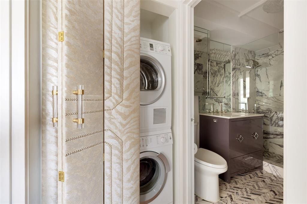 The stackable washer/dryer is hidden behind an upholstered door in the 16th floor condo at 1400 Hermann Drive.