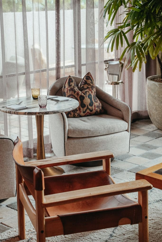Rows of windows and sheer linen curtains help bring the outdoors in. (Photo by Cristina Fisher)