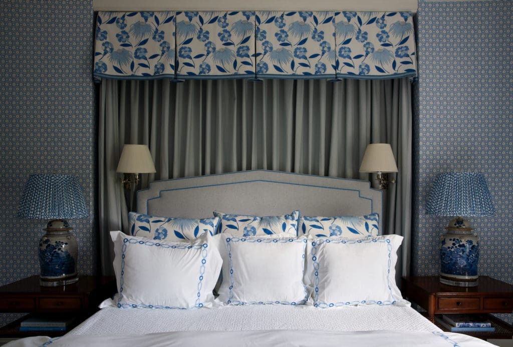A guest-bedroom canopy is Celerie Kemble for Schumacher fabric. China Seas wallpaper. Madre lamps, Fermoie fabric shades. (Photo by Pär Bengtsson)