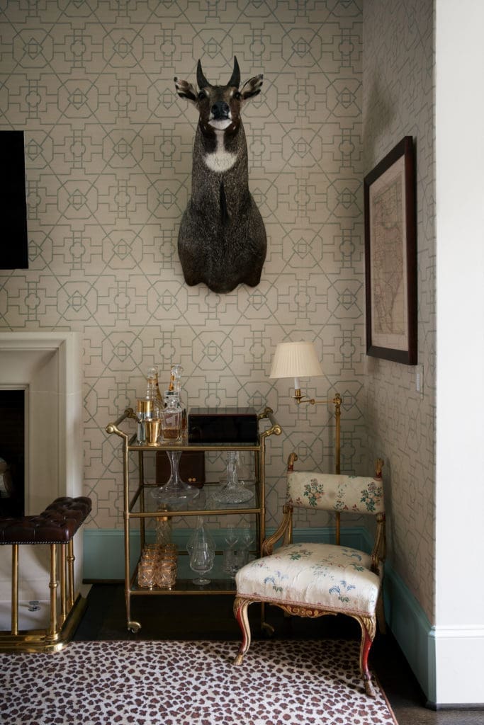The artworks in the study are family heirlooms. The bar cart and chair are antiques. (Photo by Pär Bengtsson)