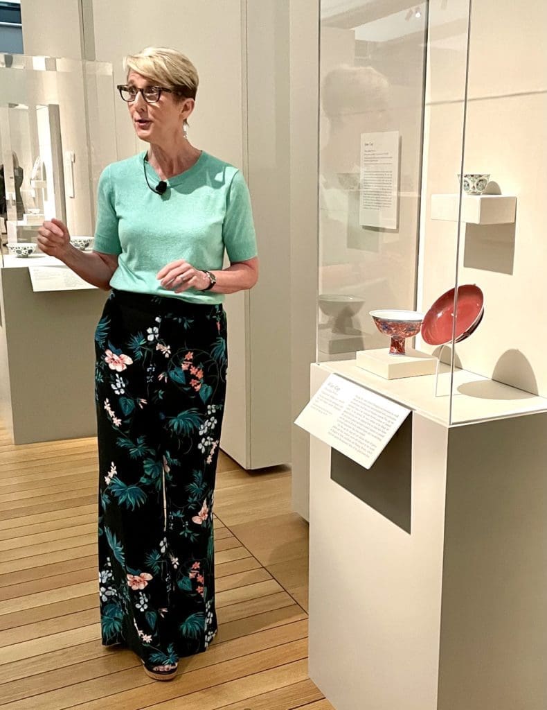 Curator Jennifer Casler Price points out the design of a small but elaborate cup in the collection. (Photo by Courtney Dabney).