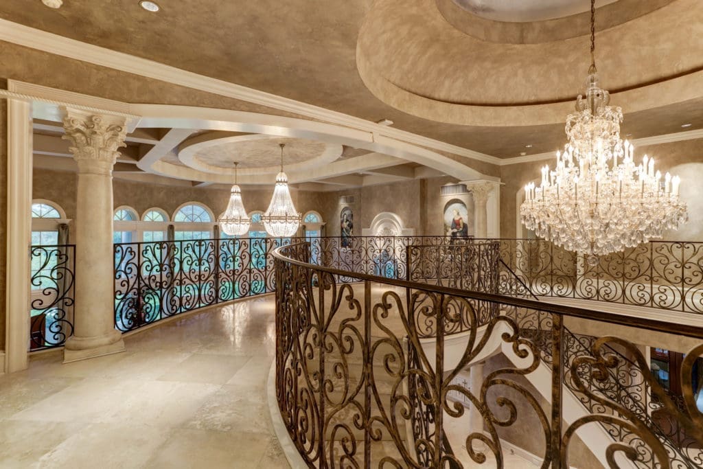 The landing at the top of the dual staircase offers stunning views into the living room. (Photo by TK Images)