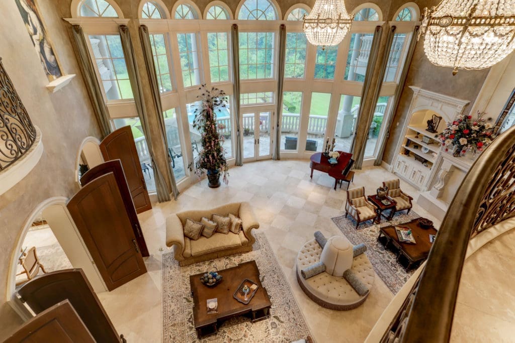 Arched doors lead from the living room into the kitchen speaking to the open floor plan of the main floor. (Photo by TK Images)