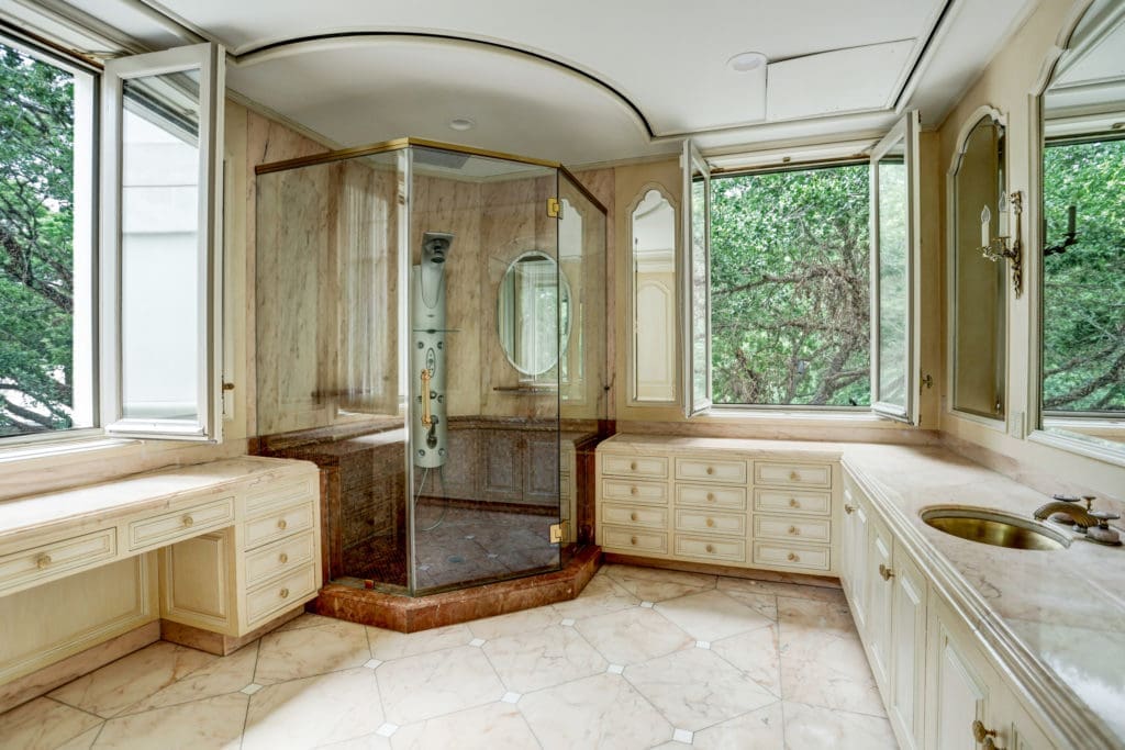 The focal point of this magnificent space is the extensive corner shower with Hansgrohe programmable tower which operates the shower head, 6 adjustable water jets, and flexible arm hand shower attachment. (Photo by TK Images)