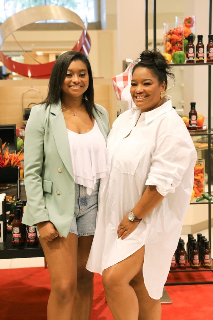 Sienna Sauce founder Tyla-Simone Crayton and her mother, Monique Crayton, partners is a thriving business, make a PA in Neiman Marcus in the Houston Galleria. (Photo by Priscilla Dickson)