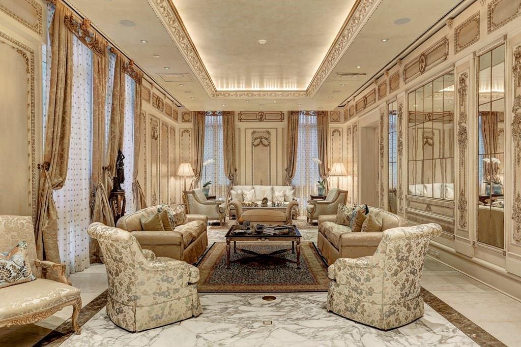 The formal reception parlor features soaring 12’ ceilings, imported Calacatta Gold marble floors with inlays, casement windows with custom silk draperies, and paneled walls with gilt-edged framing. (Photo by TK Images)