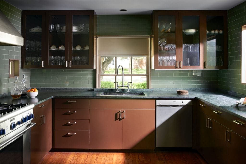 Bentley Tibbs designed the kitchen's cabinets, painted in Benjamin Moore Mink. Green glass tiles from Ann Sacks. Soapstone countertops. (Photo by Pär Bengtsson)