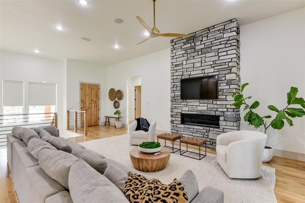 A wide open living room features a modern fireplace and plenty of room to spread out. 