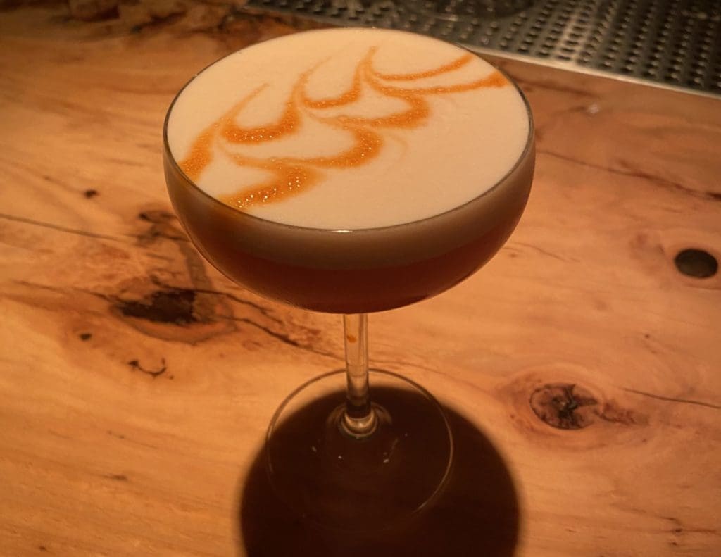Apothecary's Call Me Trinidaddy is a rum creation with pineapple infused amargo vallet, lemon, sunflower orgeat,
banana, and egg white. (Photo by Megan Ziots)