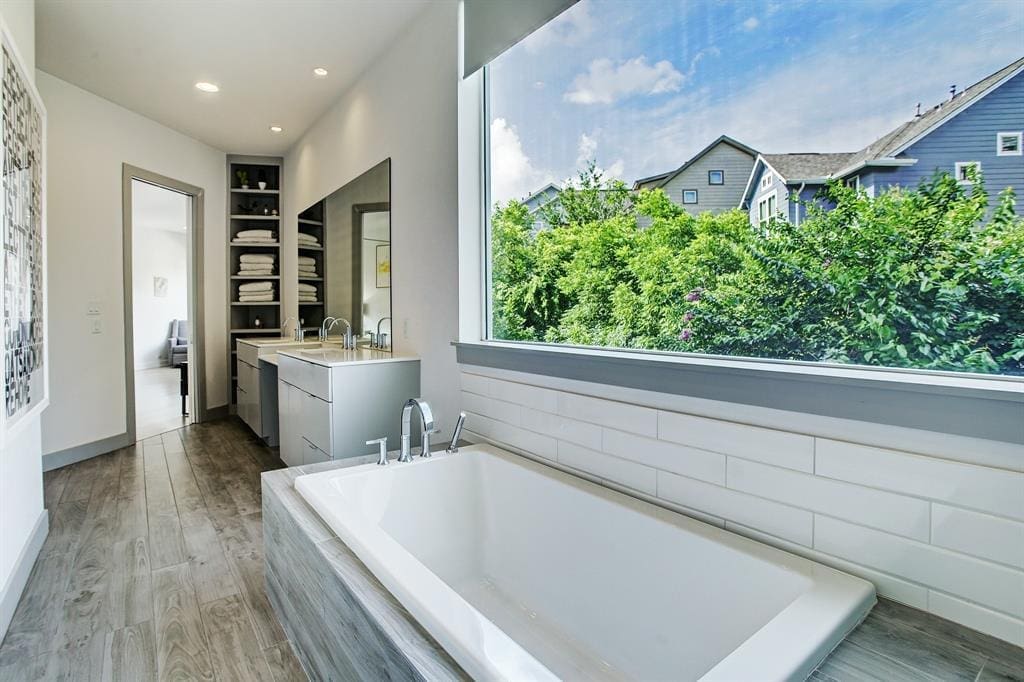 A soaking tub, shower and double sinks in the master bath at the Triangle House in The Heights.