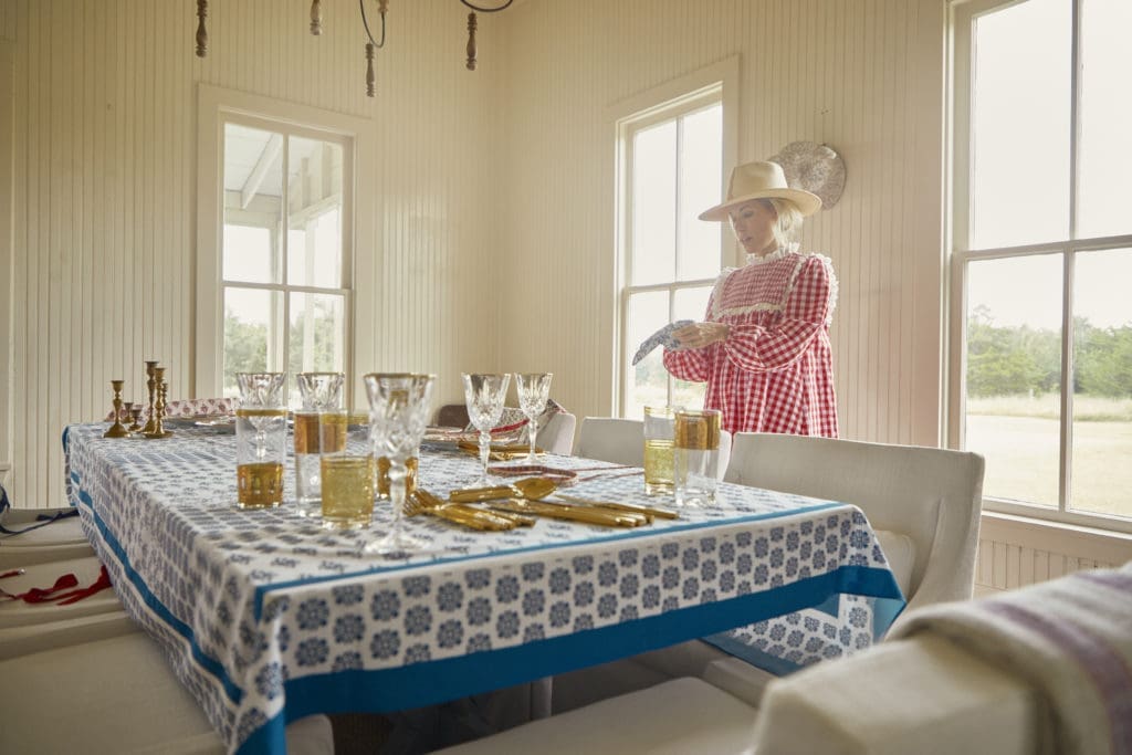 Designer Hunter Bell arranges the tabletop featuring her new line of Texas country-inspired linens.