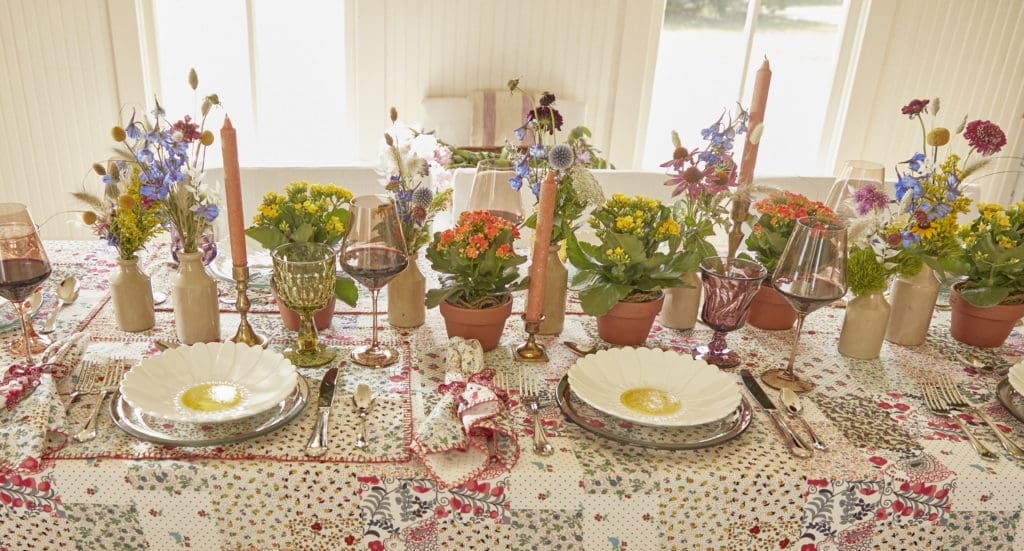 The table is set Hunter Bell's table cloth and napkins in the Patchwork pattern.