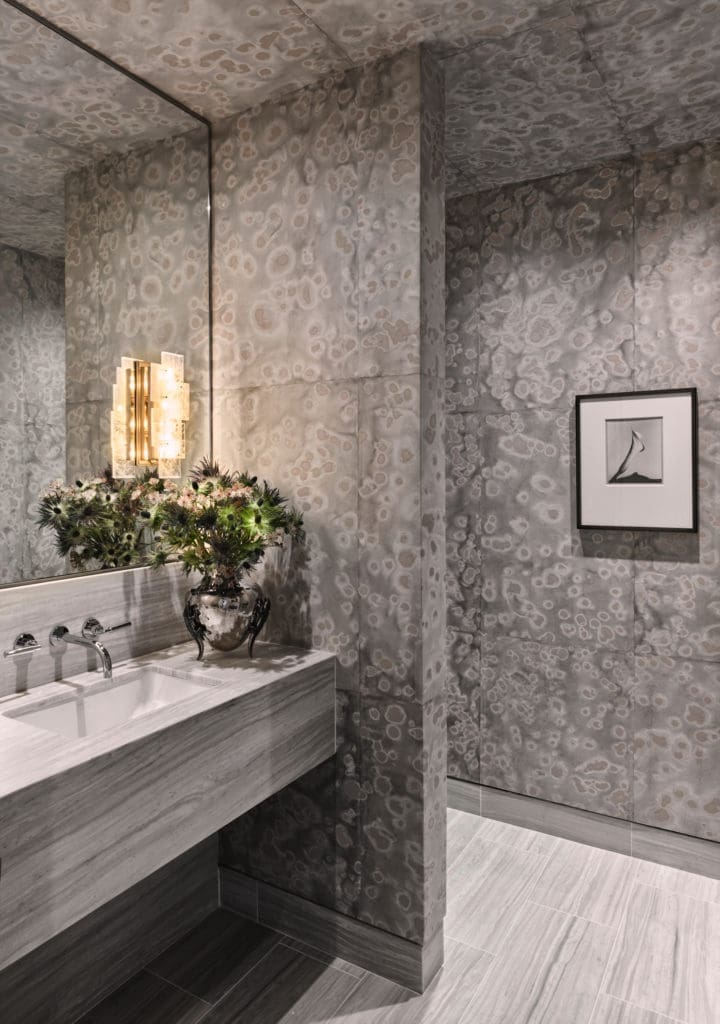 In a powder bath, Carolyn Ray's "Spotted Glaze" painting on rice paper and mulberry sheets covers walls. Pagani Studio sconce. Calla photograph by Imogen Cunningham. (Photo by Douglas Friedman)