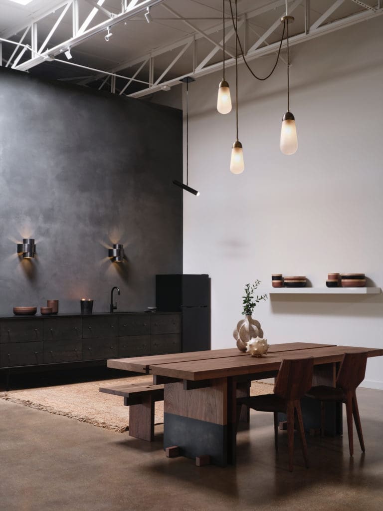 Kerstens table and benches, Belgium.
Apparatus Studio light pendant, NY. Ceramics on table are by Julie Nelson, England. Ceramics on shelf Vincent Van Duysen, Belgium. Rug by Armadillo, L.A. (Photo by Lisa Petrole)