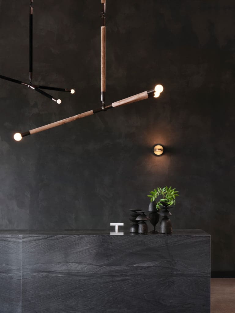 Apparatus Studio Arrow pendants, NY.
Custom stone desk and ceramics by
Jeffrey Loura, NY. (Photo by Lisa Petrole)