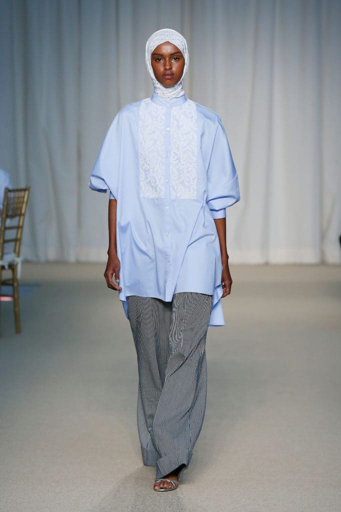 Adam Lippes blue cotton poplin lace bib shirt, navy railroad stripe trouser. (Photo courtesy of Adam Lippes)