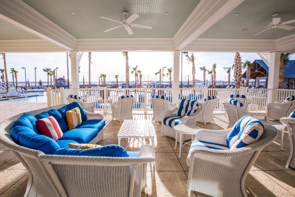 The porch at The Beach Club grants you a view of the pools on property and beyond that the marina and harbor. (Photo The Charleston Harbor Resort & Marina)