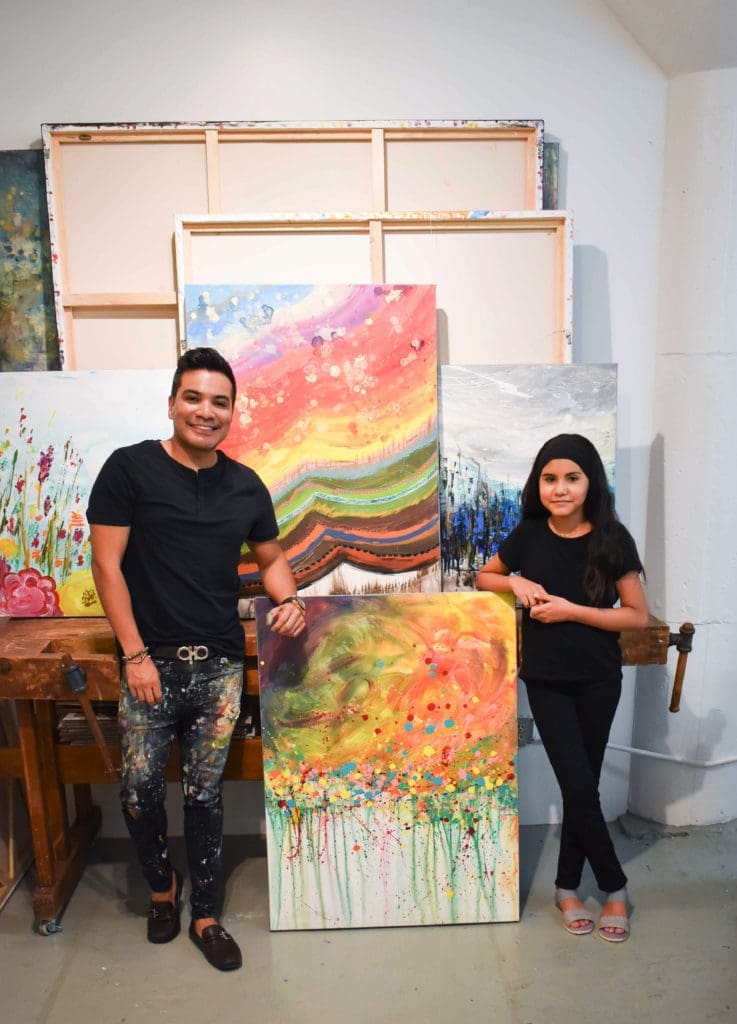 Edgar Medina and Melinda Moreno pose beside their collaboration, "Summer," 2021.