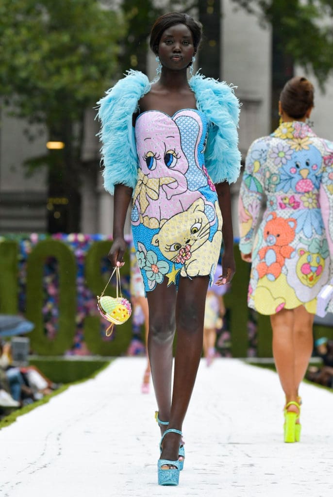 Moschino cartoon patterned dress with blue feathers. (Photo courtesy of Moschino)