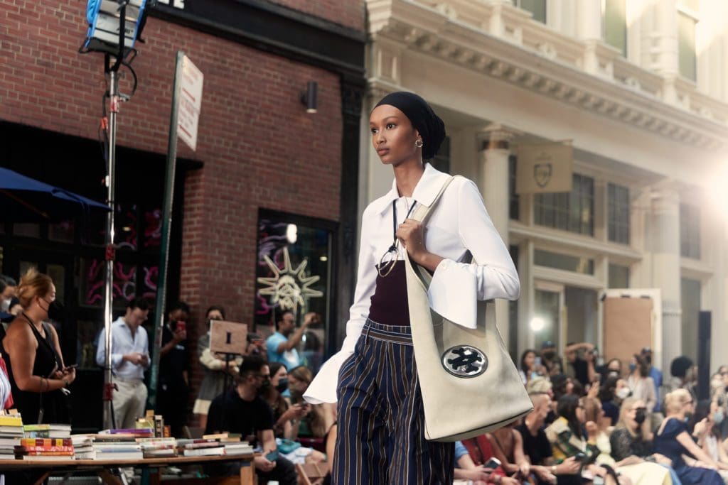 Tory Burch matte jersey shirt, tech-knit bandeau, uniform-stripe cotton pant.
Medallion tote, Medallion mule. (Photo courtesy of Tory Burch)