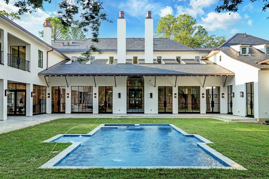 The in-ground swimming pool and spa provide a dramatic viewpoint to the back of the 12,095 square foot River Oaks mansion. (Photo by TK Images)