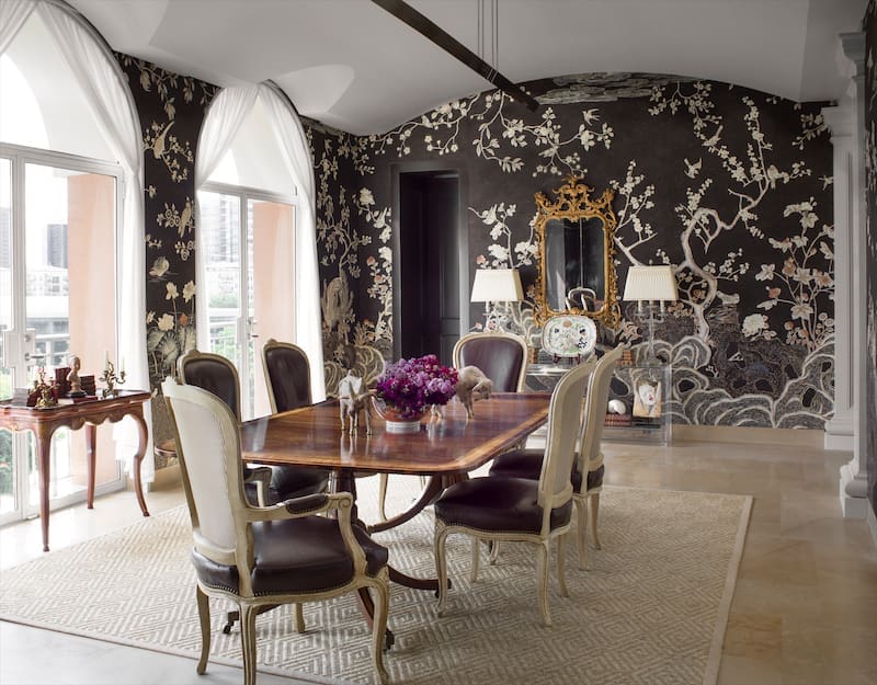 Dining-room wallpaper is de Gournay's Coco Coromandel. Antique Baccarat candlestick lamps were purchased in New Orleans, an anniversary gift from the homeowner's father to her mother. the table is 18th-century English Georgian, and the chairs, 19th-century French. (Photo: Emily Minton Redfield)
