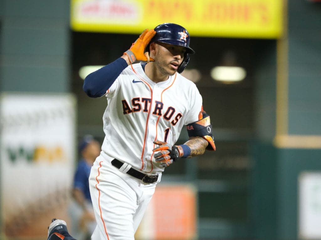 Carlos Correa lifted little Anaiah Maldonado up high in the sweetest Astros celebration yet last October. (Photo by F. Carter Smith)