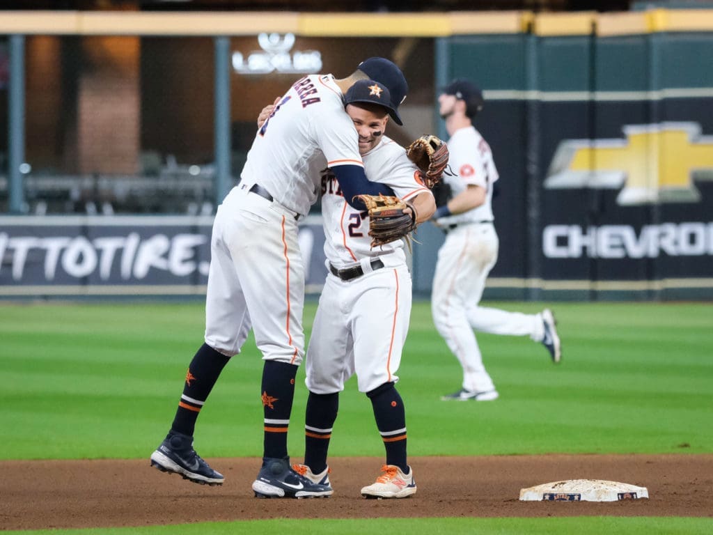 Even before he hugged his wife, Carlos Correa hugged his buddy and double play partner Jose Altuve. (Photo by F. Carter Smith)