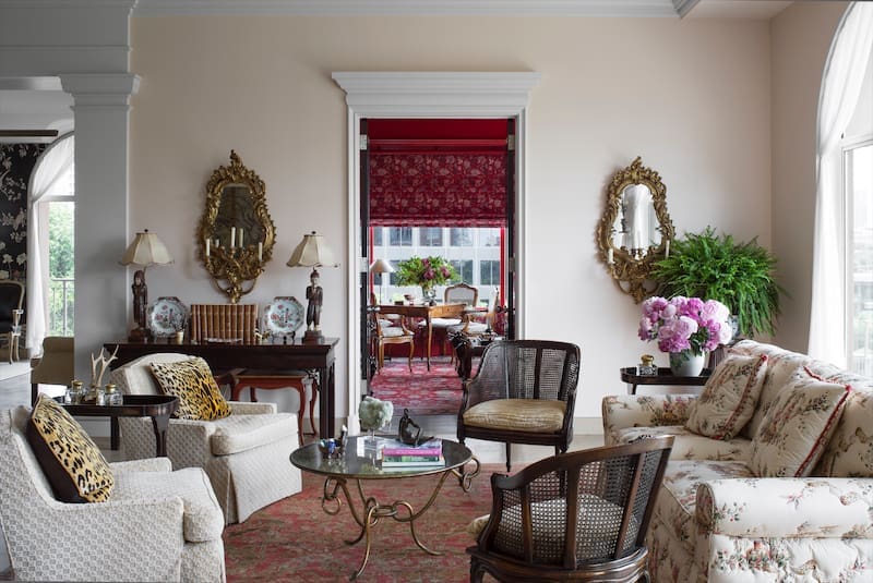 The client wanted to recreate a red-lacquer library from her previous house, so Fusch walled in a corner of the living room for this purpose and added a classical pediment over the doorway for architectural interest. (Photo: Emily Minton Redfield)