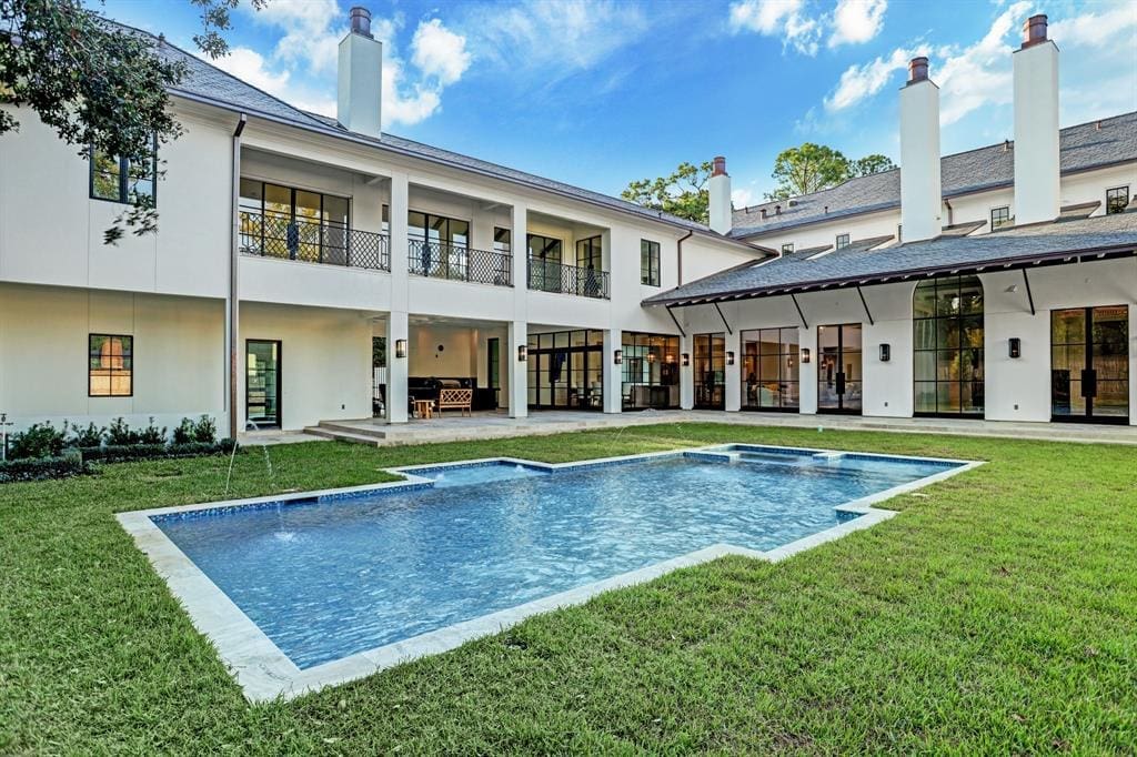 The in-ground swimming pool and spa provide a dramatic viewpoint to the back of the 12,095 square foot River Oaks mansion. (Photo by TK Images)