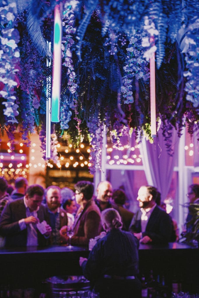 Concepted by Jeny Bania, CMO of Headington, The Joule was filled with magnolia trees, orchids, paper flowers, neon accents, and GRO Designs painted palms. (photo by BECKLEY) (Photo by Exploredinary)