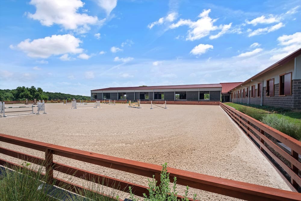 Beyond the barn, the grounds encompass four individual acre turnouts for horses to play and exercise. (Photo by Zach Spross Photography for Douglas Elliman)