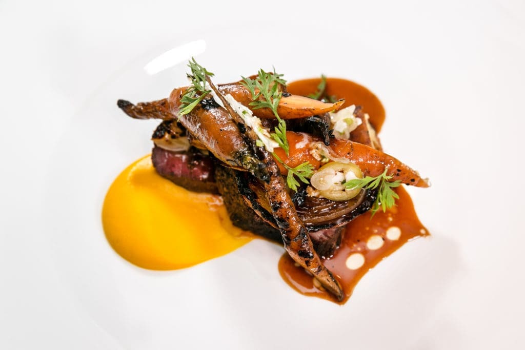 For the fourth course at the Urban Harvest Sunday Supper, Guard and Grace chef Troy Guard prepared oak-grilled Texas Wagyu sirloin. (Photo by Emily Jaschke)